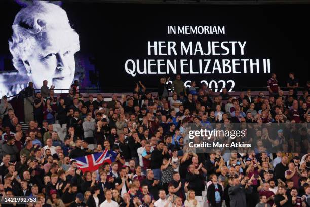 The LED board shows a photo Queen Elizabeth II as players observe a minutes silence after it was announced that Queen Elizabeth II has passed away...