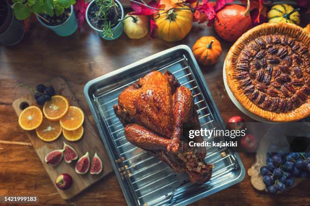 preparing stuffed turkey with side dishes for holidays - chicken roasting oven stock pictures, royalty-free photos & images