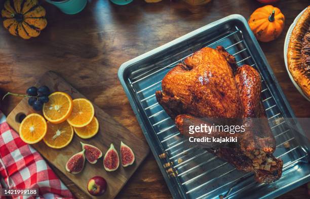 preparing stuffed turkey with side dishes for holidays - chicken roasting oven stock pictures, royalty-free photos & images