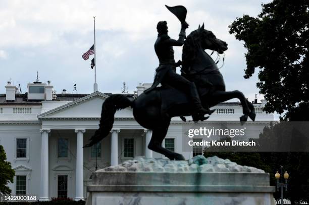 The American flag on top of the White House is lowered to half staff in memory of Queen Elizabeth II on September 08, 2022 in Washington, DC. U.S....