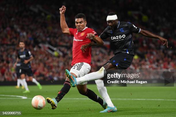 Umar Sadiq of Real Sociedad battles for possession with Casemiro of Manchester United during the UEFA Europa League group E match between Manchester...