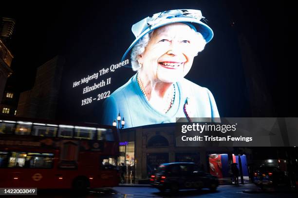 The advertising screens in Piccadilly Circus display an image of Queen Elizabeth II on September 08, 2022 in London, England. Elizabeth Alexandra...