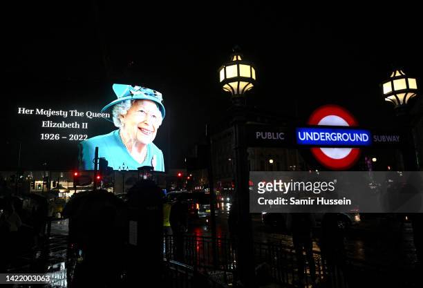 The advertising screens in Piccadilly Circus display an image of Queen Elizabeth II on September 08, 2022 in London, England. Elizabeth Alexandra...