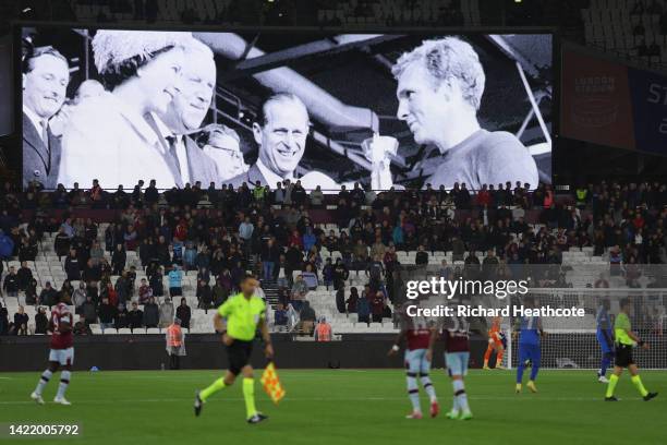 The LED board shows the images of Queen Elizabeth II awarding the Jules Rimet World Cup Trophy to Bobby Moore after England won the 1966 World Cup...