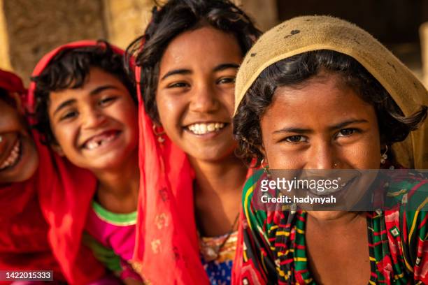 happy indian girls in desert village, india - rajasthani youth stock pictures, royalty-free photos & images