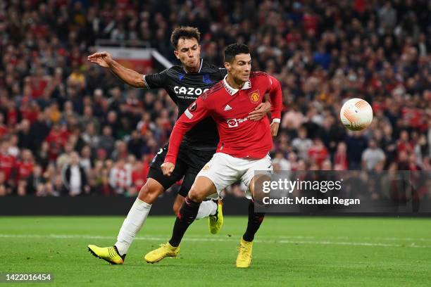 Cristiano Ronaldo of Manchester United is challenged by Martin Zubimendi of Real Sociedad during the UEFA Europa League group E match between...