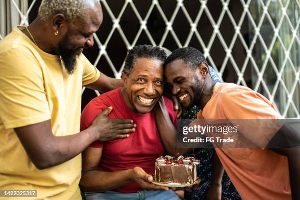 family celebrating father's birthday - birthday cake 50 stock pictures, royalty-free photos & images