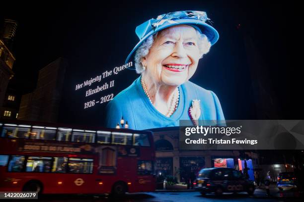 The advertising screens in Piccadilly Circus display an image of Queen Elizabeth II on September 08, 2022 in London, England. Elizabeth Alexandra...