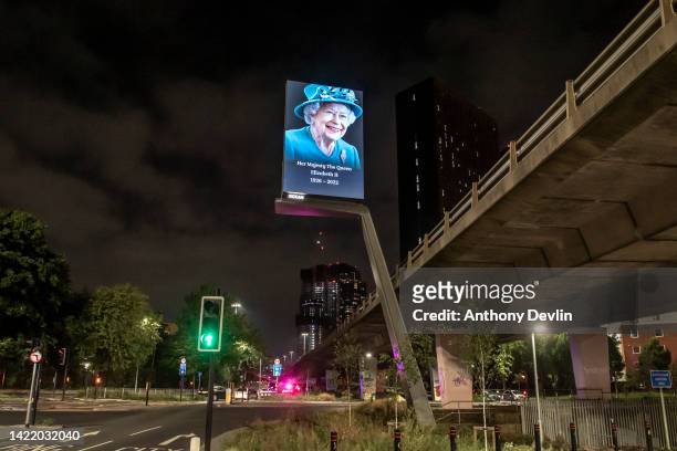 Digital advertising board beside the Mancunian Way shows an image of Queen Elizabeth II on September 08, 2022 in Manchester, England. Elizabeth...