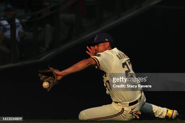 Willy Adames of the Milwaukee Brewers fields a fly ball during the eighth inning of game one of a doubleheader against the San Francisco Giants at...
