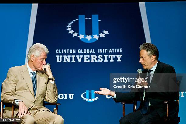 Bill Clinton and Jon Stewart speak during a panel discussion during the 5th annual 2012 Clinton Global Initiative University meeting at George...