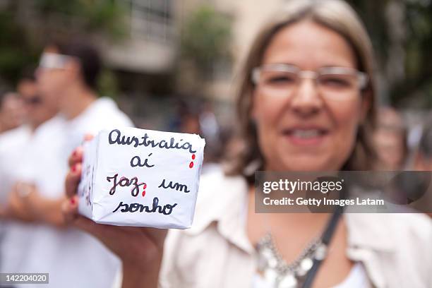 Woman holds a sign at the Australian embassy to protest against the killing of Brazilian student Roberto Laudisio Curti, on March 31, 2012 in Sao...