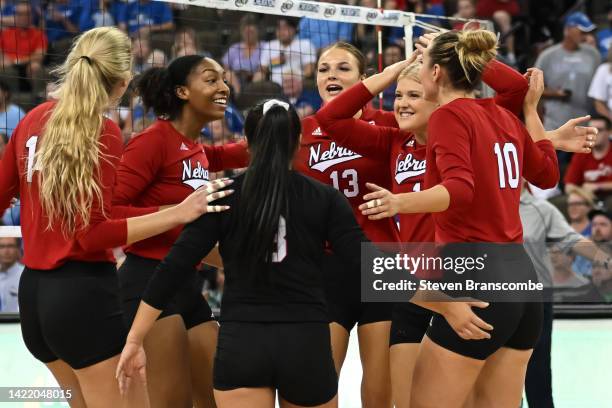 Whitney Lauenstein of Nebraska Cornhuskers, Kaitlyn Hord and Nicklin Hames celebrate a point with teammates against the Creighton Bluejays at CHI...