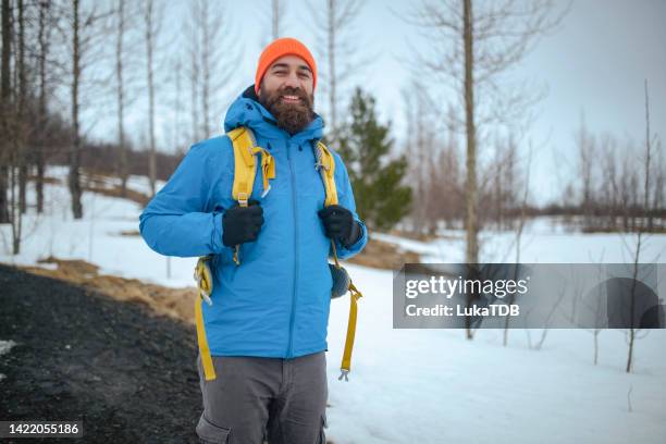 a happy mountaineer stands on a mountain and enjoys nature. isl - frozen beard stock pictures, royalty-free photos & images