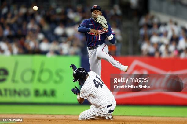 Miguel Anduijar of the New York Yankees is forced out at second base as Nick Gordon of the Minnesota Twins completes the double play in the fourth...