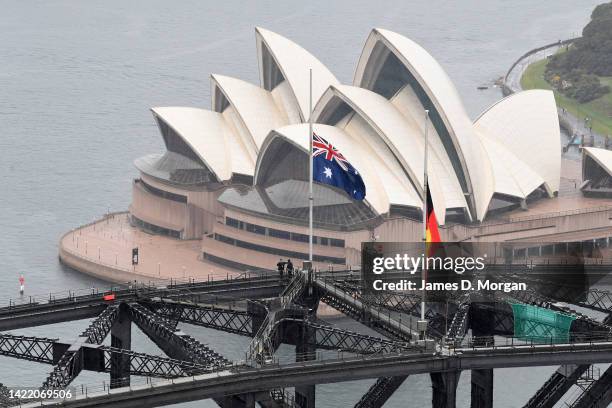 The Australian national flag and the Aboriginal flag are seen at half mast on Sydney Harbour Bridge as a sign of respect for the passing of Queen...