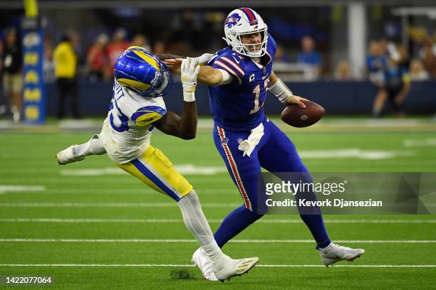 Quarterback Josh Allen of the Buffalo Bills rushes the football against safety Nick Scott of the Los Angeles Rams during the third quarter of the NFL...