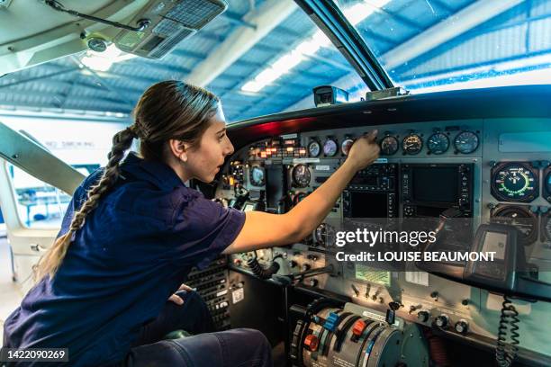 real life young female aircraft engineer apprentice at work - tradie stock pictures, royalty-free photos & images