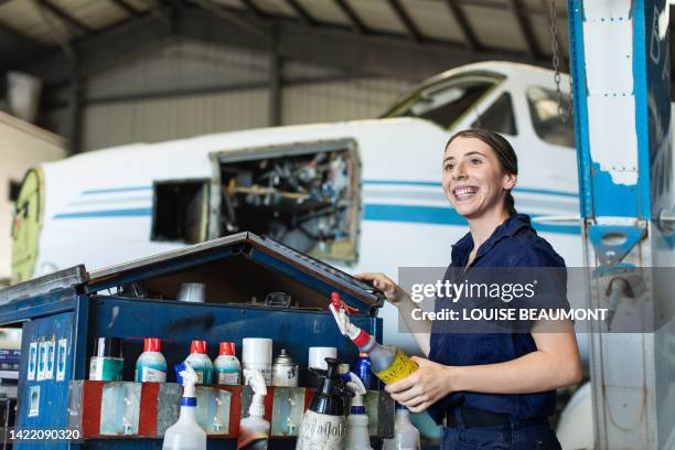 real life young female aircraft engineer apprentice at work - tradie stock pictures, royalty-free photos & images