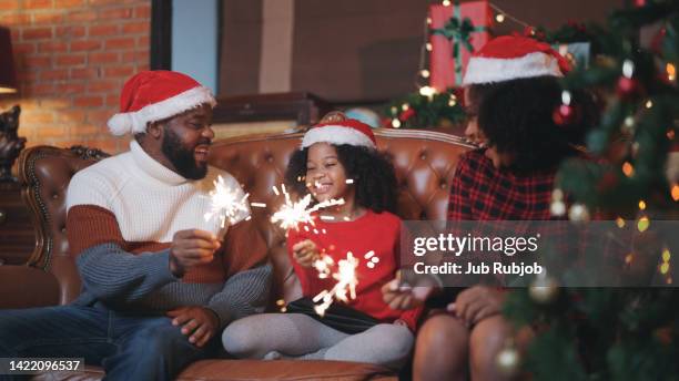 parents and children are very happy and happy to decorate the house during the christmas period. holding fire and dancing to wish happiness in the new yea - the red room opening party inside fotografías e imágenes de stock