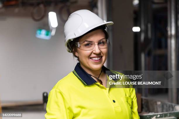portrait of a real life female electrician at work - tradie stock pictures, royalty-free photos & images