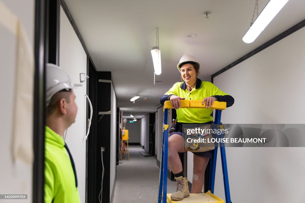 Real life female electrician and her coworker at work