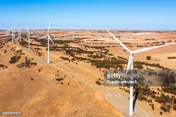 wind farm out in a paddock. - climate change australia stock pictures, royalty-free photos & images