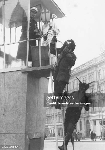 Nikolo and Krampus visit a Vienna traffic police men. About 1960.
