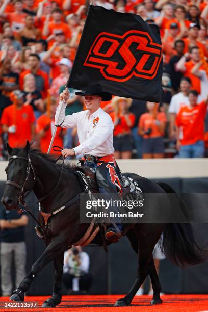 Bullet and the Spirit Rider celebrate a touchdown by the Oklahoma State Cowboys against the Central Michigan Chippewas in the first quarter at Boone...