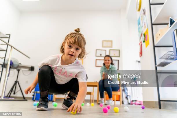 down syndrome: occupational therapy - kid looking down stock pictures, royalty-free photos & images