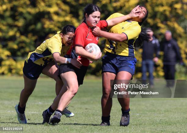 Manukura fullback Naia Sutherland fends off Auckland Girls Grammar players during the National 1st XV Championships on September 09, 2022 in...