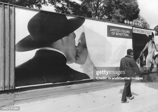 Billboard with Benetton advertisement with the subject of a priest kissing a nun. Vienna. 18 September 1991.