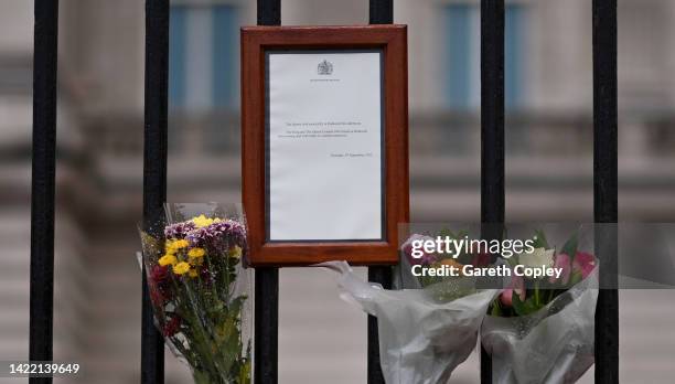 Tributes are placed alongside Queen's death notice on gates of Buckingham Palace on September 09, 2022 in London, United Kingdom. Elizabeth Alexandra...
