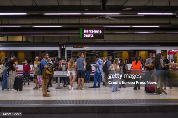 Travellers wait for the arrival of a train on one of the platforms at Sants station, on September 9 in Barcelona, Catalonia, Spain. Adif technicians...