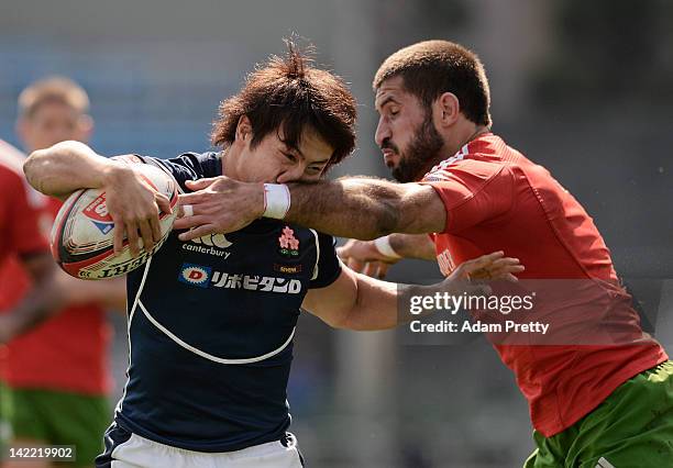 Shohei Toyoshima of Japan is tackled by of Goncalo Foro Portugal in the Japan vs Portugal match during day two of the Tokyo Sevens at Prince Chichibu...