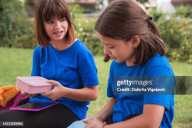 girls holding lunch box - september 12 stock pictures, royalty-free photos & images