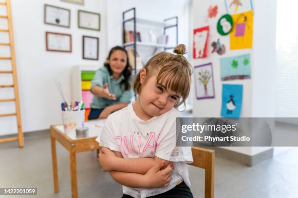 a little girl sitting on the chair infront of the desk feeling sad and angry. child loneliness, autism awareness, traumatic, the problem of child development, sadness and fearful. - weakness stock pictures, royalty-free photos & images