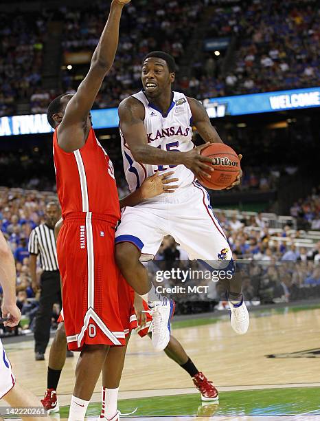 Elijah Johnson of Kansas goes up against Evan Ravenel of Ohio State in the NCAA Tournament semifinals at the Mercedes-Benz Superdome in New Orleans,...