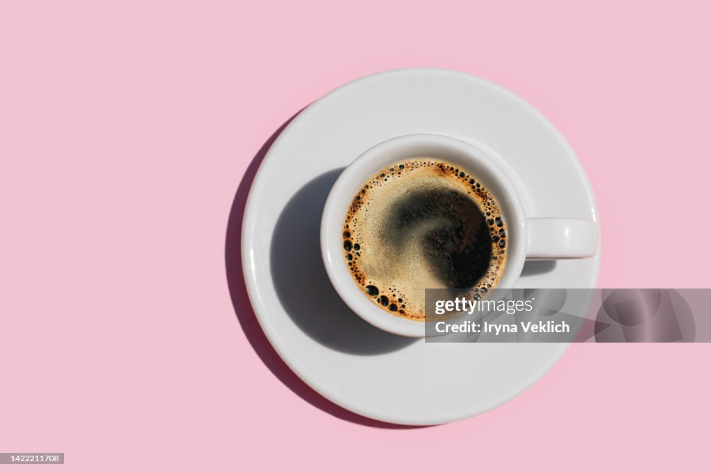 Directly Above Shot Of Coffee On Pink color Background.