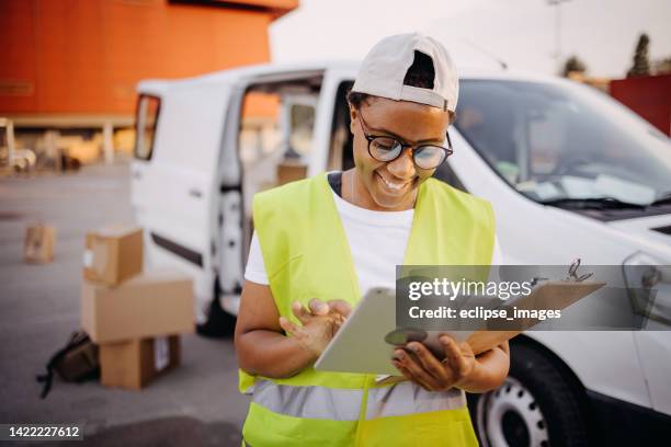 delivering parcels. - delivery truck stock pictures, royalty-free photos & images