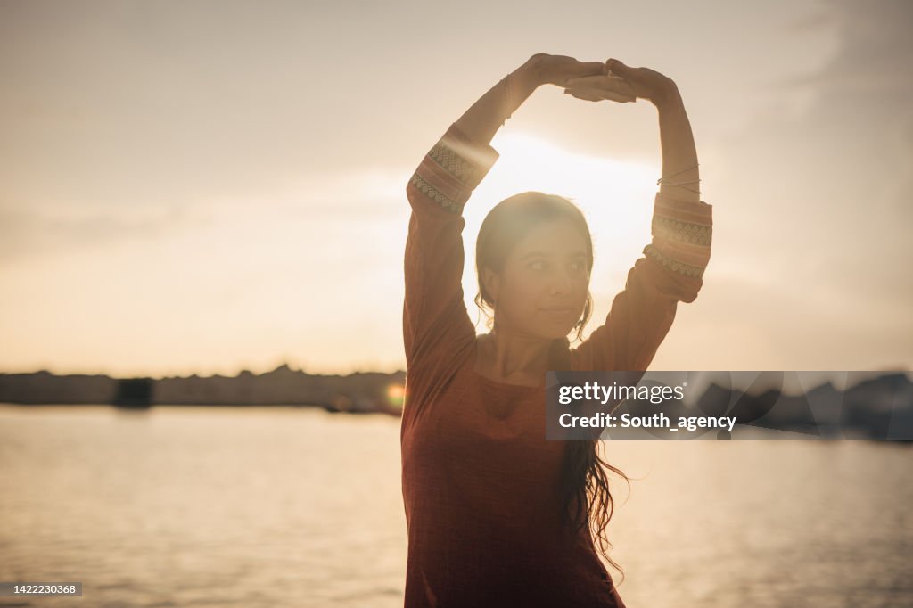 Beautiful Indian girl traditional dancing on the beach