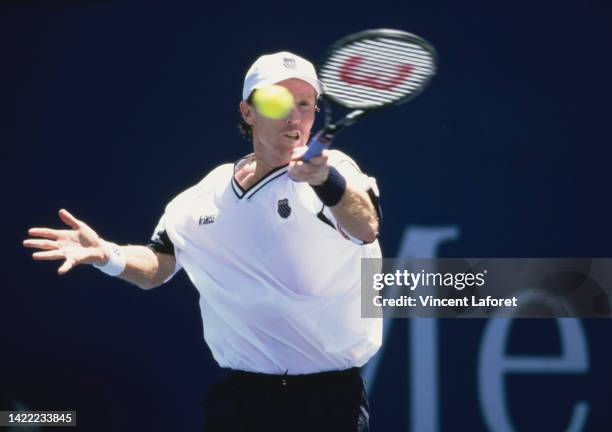 Mark Woodforde from Australia plays a forehand return against Thomas Enqvist of Sweden during their Men's Singles First Round match of the...