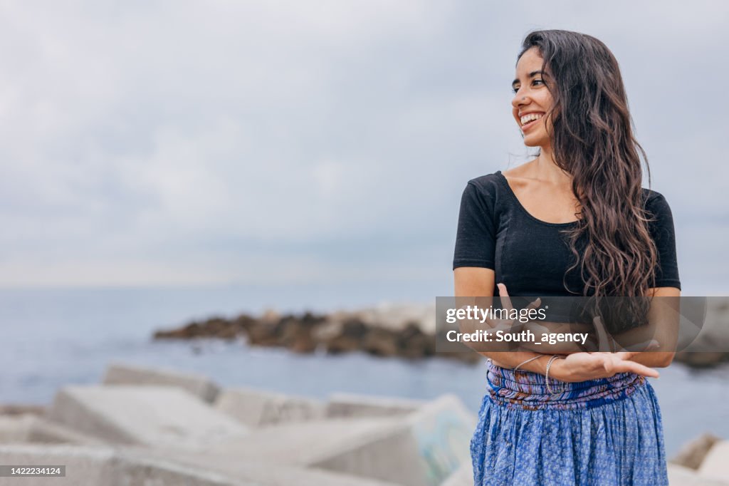 Beautiful Indian girl traditional dancing on the beach