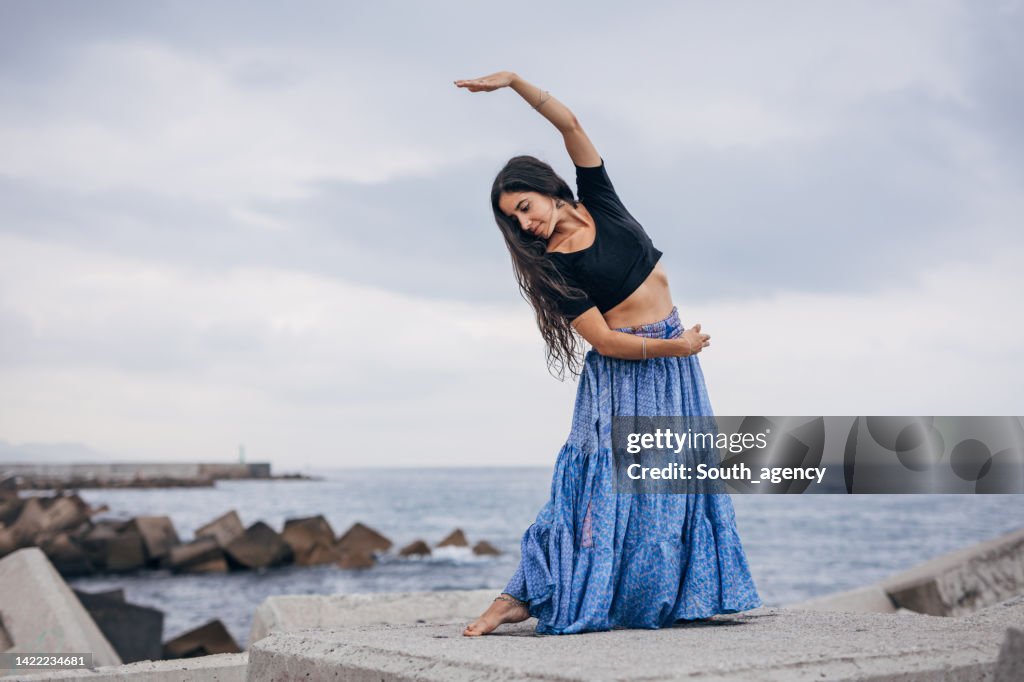 Beautiful Indian girl traditional dancing on the beach