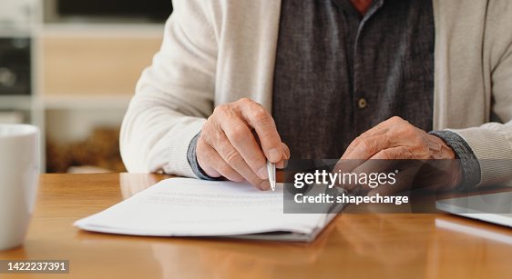 Hands of senior retirement woman writing a finance savings budget plan on paper or legal trust fund for after her funeral. Elderly person apply for pension or government financial support and help Hands of senior retirement woman writing a finance savings budget plan on paper or legal trust fund for after her funeral. Elderly person apply for pension or government financial support and help