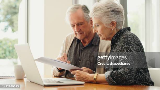 senior couple with laptop and budget document, paperwork or finances for retirement plan, pension, funeral planning expenses. married man and woman discuss their will and estate or mortgage home loan - pension stock pictures, royalty-free photos & images