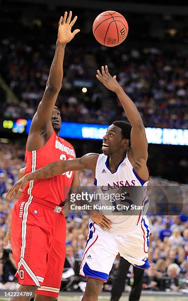 Kansas' Elijah Johnson shoots over the defense of Ohio State's Evan Ravenel in the NCAA Tournament semifinals at the Mercedes-Benz Superdome in New...