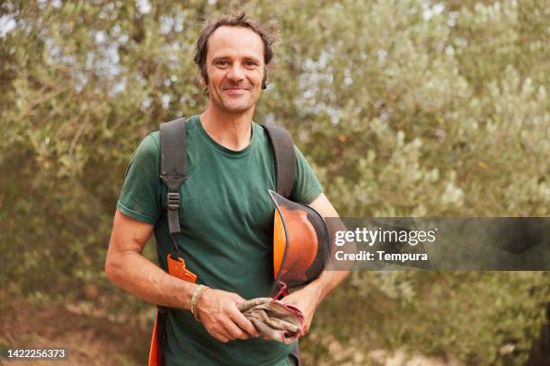 a professional gardener's portrait looking at the camera. - skogshuggare bildbanksfoton och bilder