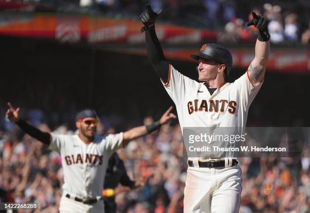 Bryce Johnson of the San Francisco Giants celebrates after scoring in front of Wilmer Flores who hit a two-run walk-off home run to defeat the...