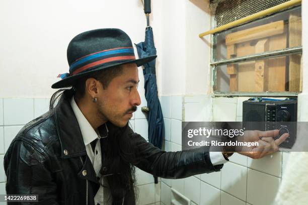 hipster is using an old radio to listen to music - 90s rap stock pictures, royalty-free photos & images